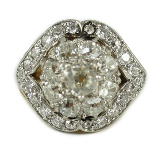 An early to mid 20th century continental gold and diamond set shaped circular cluster ring